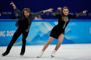 Kaitlin Hawayek and Jean-Luc Baker, of the United States, perform their routine in the ice dance competition during figure skating at the 2022 Winter Olympics, Saturday, Feb. 12, 2022, in Beijing. (AP Photo/Bernat Armangue)