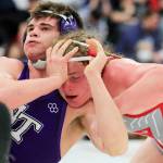 North Thurstons Bruce Price attempts to fend off Stanwoods Mason Ferguson on Saturday evening during the 3A Regional 1 boys wrestling tournament at Snohomish High School in Snohomish. (Kevin Clark / The Herald)