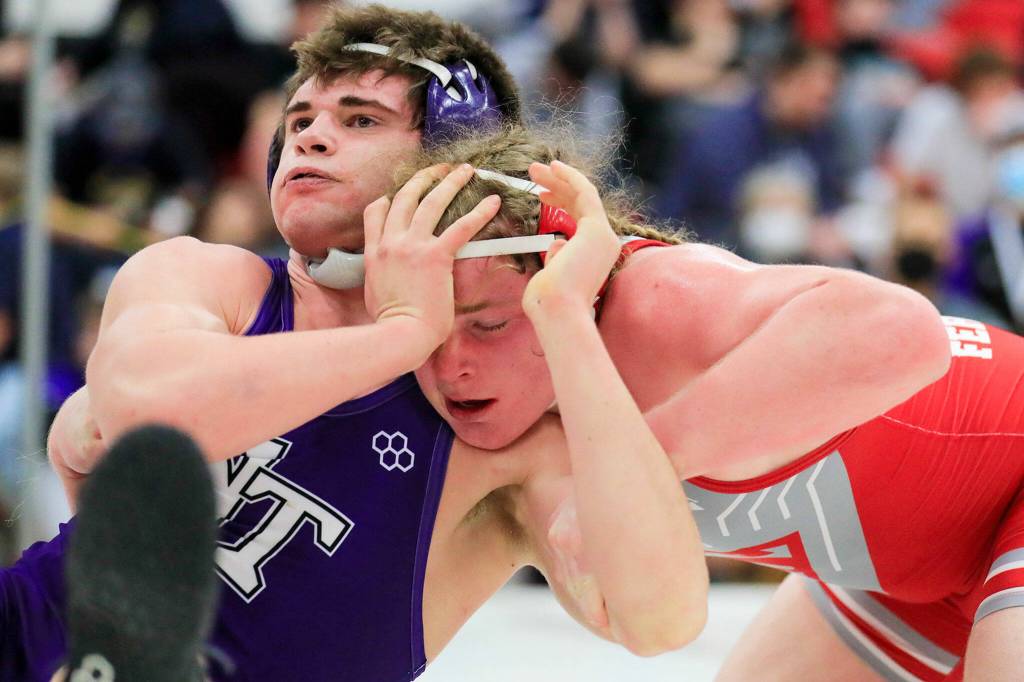 North Thurstons Bruce Price attempts to fend off Stanwoods Mason Ferguson on Saturday evening during the 3A Regional 1 boys wrestling tournament at Snohomish High School in Snohomish. (Kevin Clark / The Herald)