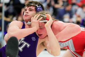 North Thurston’s Bruce Price attempts to fend off Stanwood’s Mason Ferguson Saturday evening during the 3A Regional 1 boys wrestling tournament at Snohomish High School in Snohomish, Washington on February 12, 2022.  (Kevin Clark / The Herald)