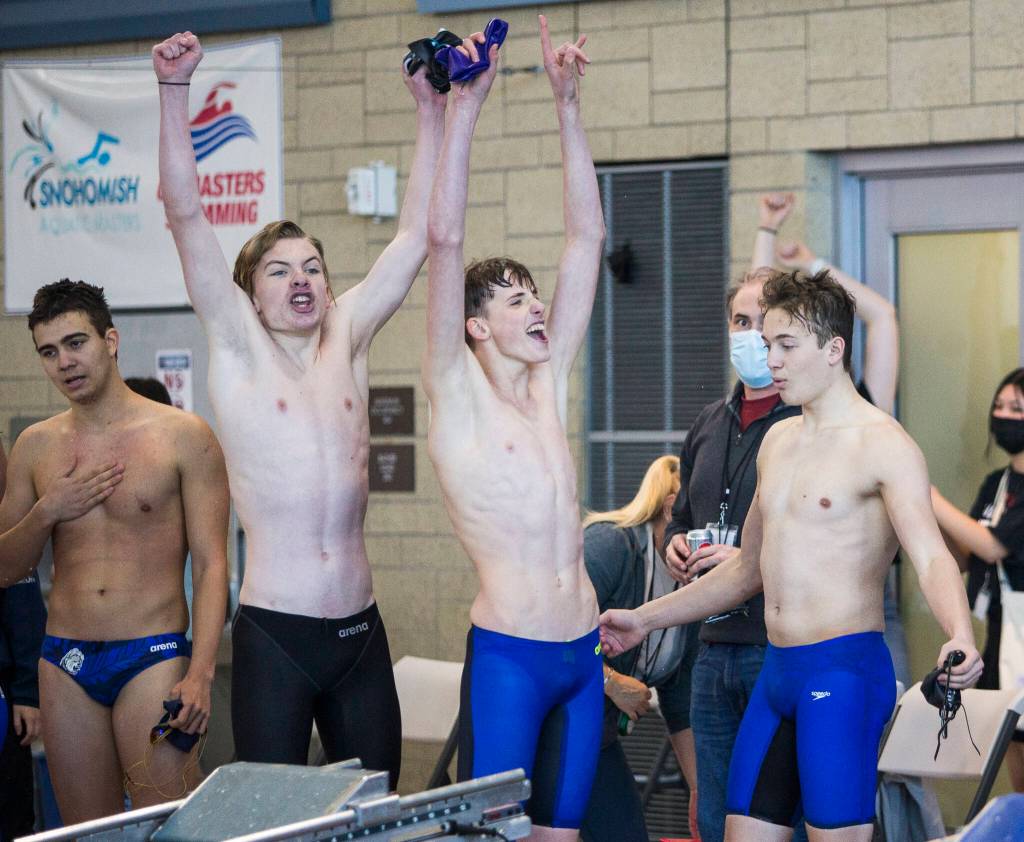 Lake Stevens swimmers react to their coach Brady Dykgraaf being named ԃoach of the Yearՠand winning the 4A Boys Districts swim meet on Saturday, Feb. 12, 2022 in Snohomish, Wa. (Olivia Vanni / The Herald)