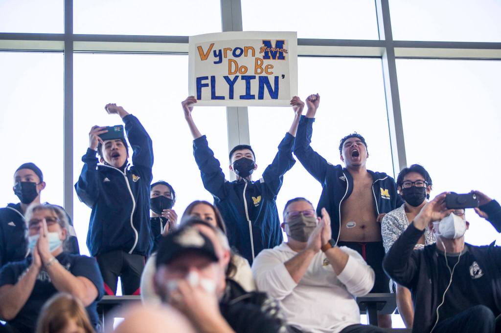 Mariner swimmers cheer on their teammate Vyron Domingo during his race at the 4A Boys Districts swim meet on Saturday, Feb. 12, 2022 in Snohomish, Wa. (Olivia Vanni / The Herald)