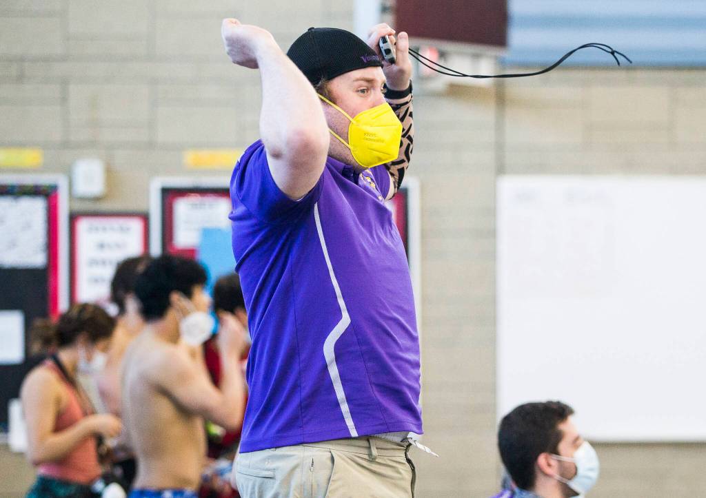 Lake Stevens head coach .. reacts to his swimmer Garrett Chesley winning the 100 Yard Backstroke during the 4A Boys Districts swim meet on Saturday, Feb. 12, 2022 in Snohomish, Wa. (Olivia Vanni / The Herald)