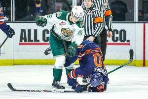 The Silvertips' Olen Zellweger (48) takes down the Blazers' Luke Toporowski during a game on Saturday, Feb. 12, 2022, at Angel of the Winds Arena in Everett. (Kristin Ostrowski / Everett Silvertips)