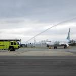 An Alaska Airlines Boeing 737 is given a water salute after landing Thursday at Paine Field in Everett. (Ryan Berry / The Herald)