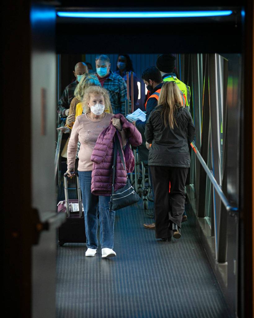 Passengers disembark an Alaska Airlines 737 at Paine Field in Everett on Thursday. The plane, arriving from Phoenix, was the first regularly scheduled 737 to serve passengers at Paine Field. Alaska up to now has deployed smaller Embraer jets to Everett. (Ryan Berry / The Herald)
