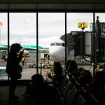 Flyers wait to become the first passengers to depart on a Boeing 737 from Paine Field on Thursday in Everett. (Ryan Berry / The Herald)