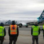 Airport workers watch as an Alaska Airlines Boeing 737 embarks on the first 737 flight out of Paine Field Airport Thursday, Feb. 17, 2022, in Everett, Washington. (Ryan Berry / The Herald)