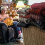 Vicki Wahl knits scarves at her home in Lake Stevens on Feb. 17. More than 170 of her scarves will be handed out during this years homelessness count. (Kevin Clark / The Herald )