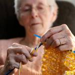 Vicki Wahl knits scarves at her home in Lake Stevens on Feb. 17. (Kevin Clark / The Herald )