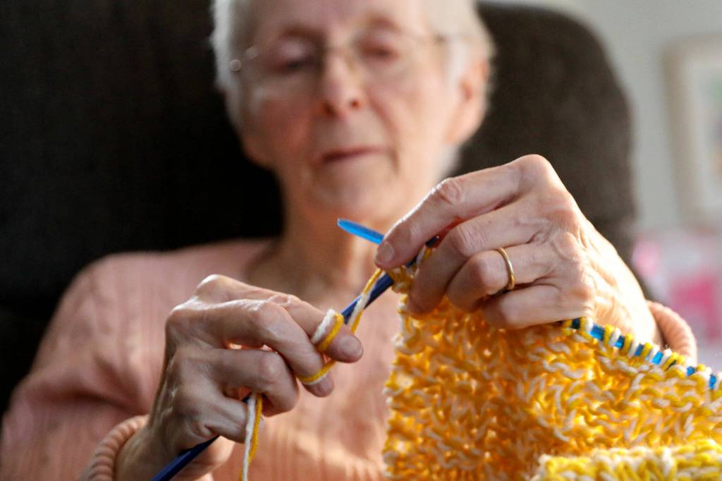 Vicki Wahl knits scarves at her home in Lake Stevens on Feb. 17. (Kevin Clark / The Herald )