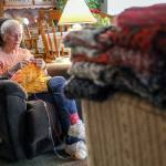 Vicki Wahl knits scarves at her home in Lake Stevens, Washington on February 17, 2022. More than 170 of her scarves will be handed out during this years’ homelessness count.  (Kevin Clark / The Herald )