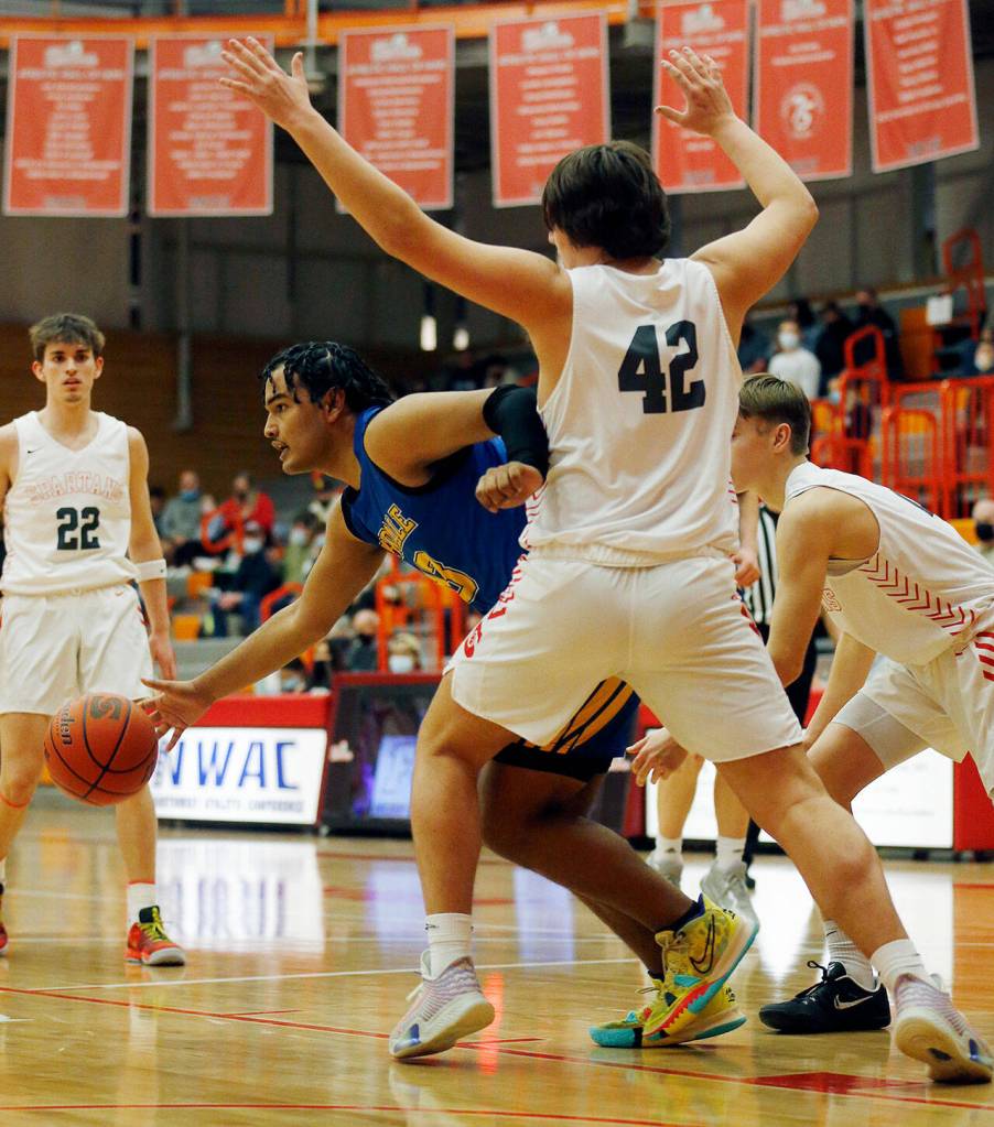 Ferndales Jazen Guillory evades defenders with the ball against Stanwood during a 3A District 1 Tournament semifinal game on Wednesday at Everett Community College. (Ryan Berry / The Herald)