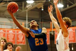 Ferndale’s Jazen Guillory drives through the paint and goes for a layup against Stanwood Wednesday, Feb. 16, 2022, at Everett Community College in Everett, Washington. (Ryan Berry / The Herald)