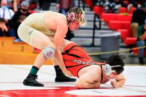 Arlington’s Trevor Latta wrestles Monroe’s Brian Zebley Jr. Saturday evening during the 3A Regional 1 boys wrestling tournament at Snohomish High School in Snohomish, Washington on February 12, 2022.  (Kevin Clark / The Herald)