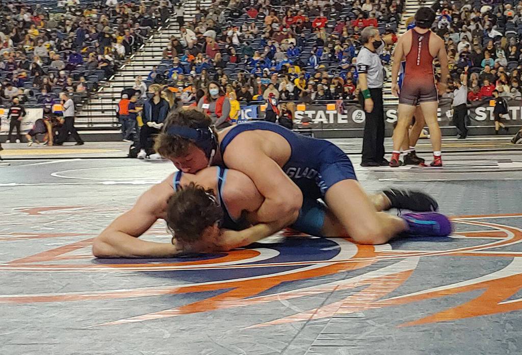 Glacier Peaks Jacob Erickson (top) works to pin Matthew Ager of Rogers (Puyallup) in a Class 4A 220-pound quarterfinal match at Mat Classic XXXIII on Feb. 18, 2022, at the Tacoma Dome. (Zac Hereth / The Herald)