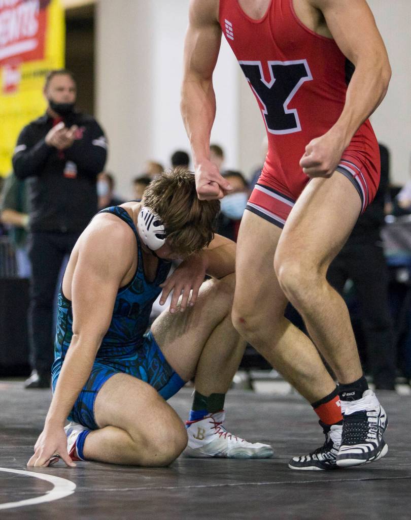 Shorewoods Hunter Tibodeau hangs his head after being defeated by Yelms Logan Play during the Mat Classic XXXIII on Saturday in Tacoma. (Olivia Vanni / The Herald)