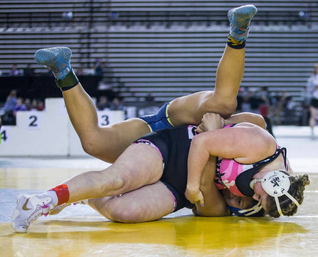 Marysville Pilchucks Alivia White flips and pins Burlingtons Delaney Cobbs during the Girls 190-pound championship match at the Mat Classic XXXIII on Saturday in Tacoma. (Olivia Vanni / The Herald)