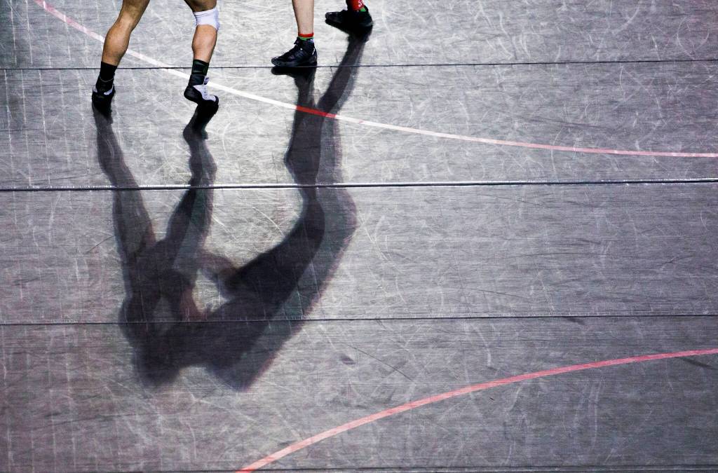 Wrestlers shadows are cast on wrestling mats during the Mat Classic XXXIII on Saturday in Tacoma. (Olivia Vanni / The Herald)