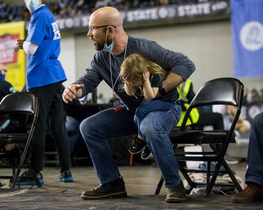 Glacier Peak coach Jordan Gere yells instructions to his wrestler during the Mat Classic XXXIII on Saturday in Tacoma. (Olivia Vanni / The Herald)