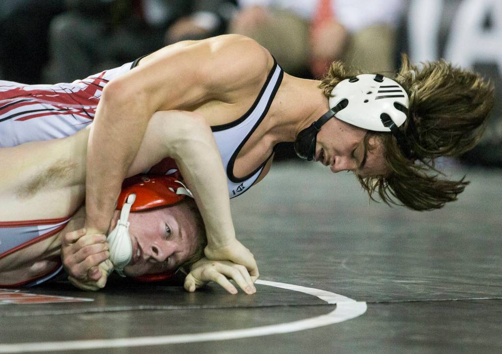 Stanwoods Tyler Rhue wrestles North Centrals Kenndyl Mobley during the 3A 126-pound championship match at the Mat Classic XXXIII on Saturday in Tacoma. (Olivia Vanni / The Herald)