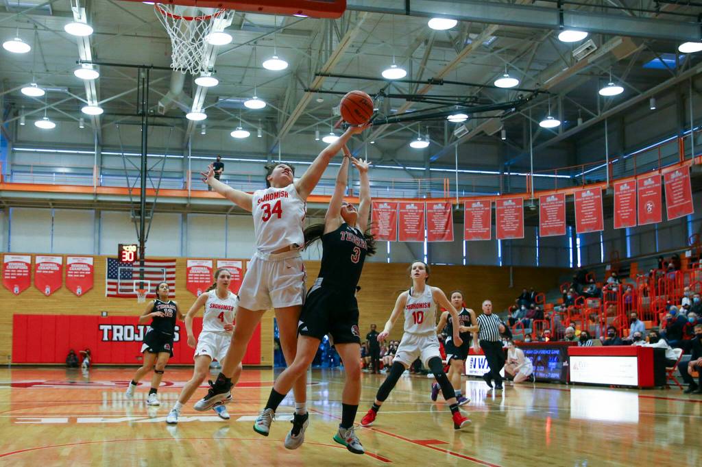 Snohomishs Tyler Gildersleeve-Stiles, left and Mountlake Terraces Ainsley Ward jump for a rebound Saturday afternoon at during the 3A District Tournament at Everett Community College in Everett, Washington on February 19, 2022. (Kevin Clark / The Herald )