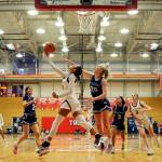 Everetts Alana Washington attempts an underhand layup with Meadowdales McKenna Kuecker trailing Saturday afternoon at during the 3A District Tournament at Everett Community College in Everett, Washington on February 19, 2022. (Kevin Clark / The Herald )
