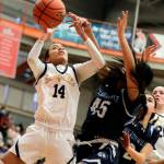 Everetts Mae Washington gathers a loose ball with Meadowdales Samantha Medina fouling Saturday afternoon at during the 3A District Tournament at Everett Community College in Everett, Washington on February 19, 2022. (Kevin Clark / The Herald )