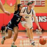 Everetts Ella Sylvester controls the dribble with Meadowdales Jenaly Gabriel adding pressure Saturday afternoon at during the 3A District Tournament at Everett Community College in Everett, Washington on February 19, 2022. (Kevin Clark / The Herald )