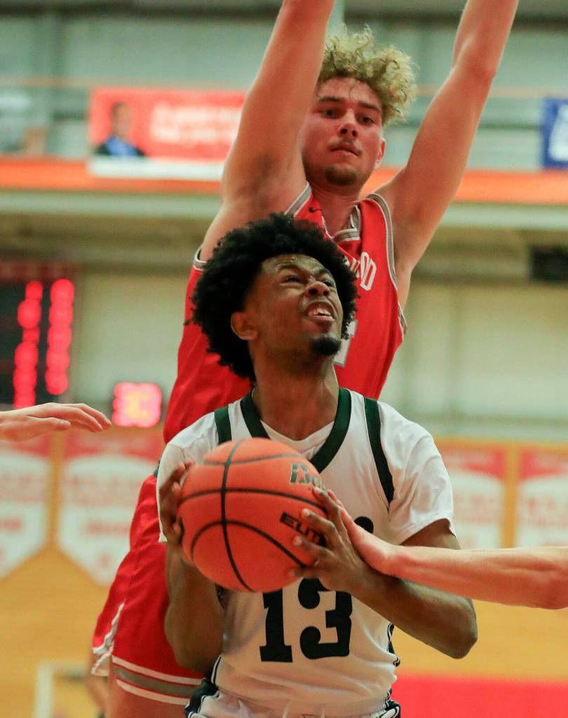 Shorecrests Newton Pepple looks to score with Stanwoods Kaeden McGlothin defending Saturday afternoon at during the 3A District Tournament at Everett Community College in Everett, Washington on February 19, 2022. (Kevin Clark / The Herald )
