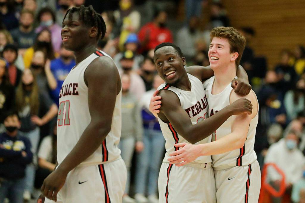 Mountlake Terraces Zaveon Jones, Jeffrey Anyimah and Adison Mattix watch the free throws that seal their victory over Ferndale for the title Saturday evening at during the 3A District Tournament at Everett Community College in Everett, Washington on February 19, 2022. (Kevin Clark / The Herald )