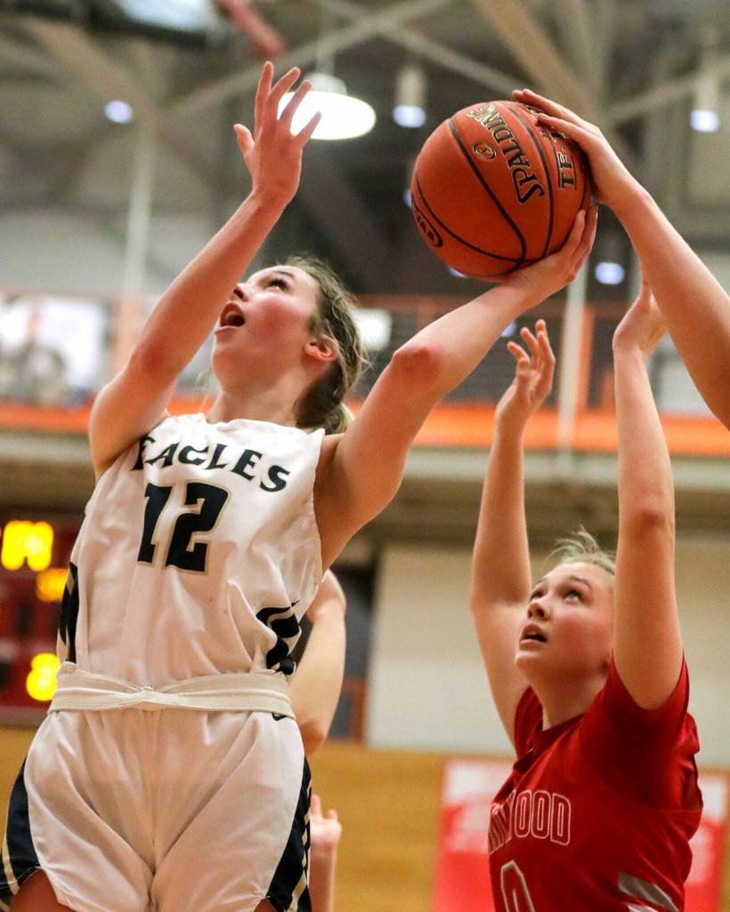 Arlingtons Hannah Rork shot is blocked Saturday evening at during the 3A District 1 Title game at Everett Community College in Everett, Washington on February 19, 2022. (Kevin Clark / The Herald )
