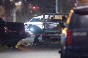 Portland police respond, on Saturday, Feb. 19, 2022, to a shooting in the area of Normandale Park in Northeast Portland, Ore. One person was killed and five others were wounded in a shooting at the Portland park where a march was planned to protest police violence. (Beth Nakamura/The Oregonian via AP)