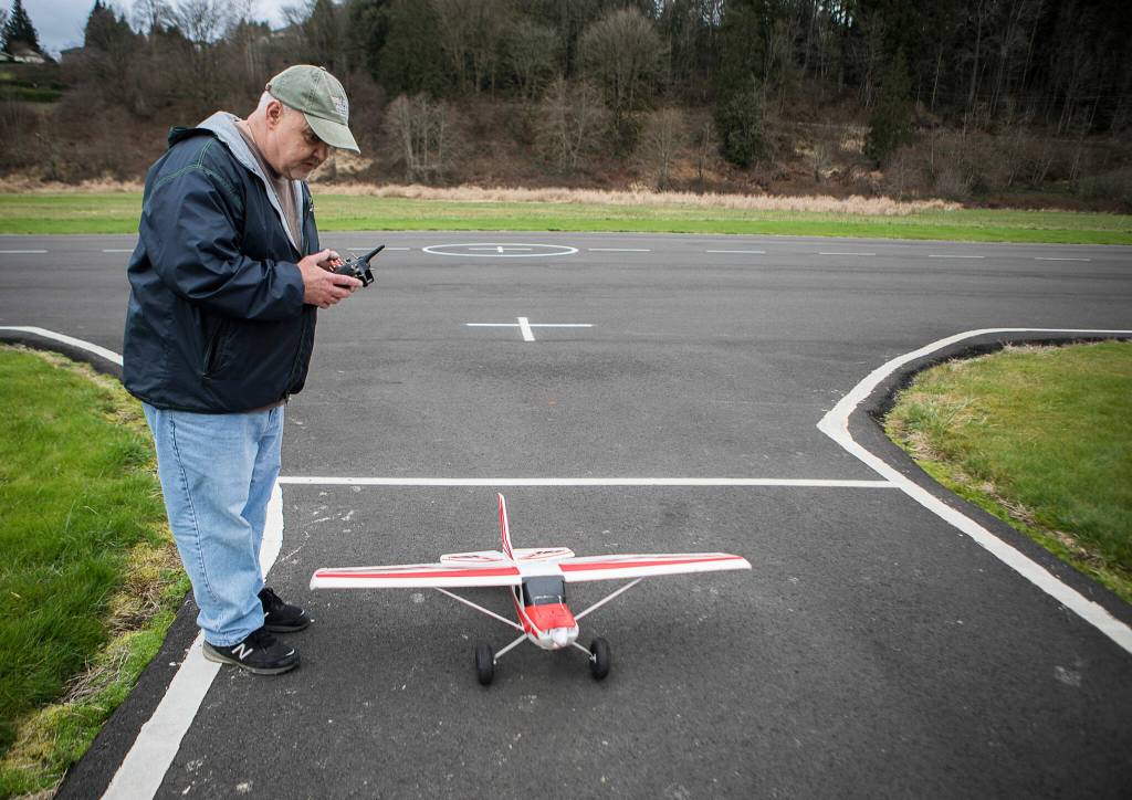 Paul Butterworth drives his Bigfoot model airplane off the Snohomish Radio Aero Club field on Feb. 17 in Snohomish. (Olivia Vanni / The Herald)
