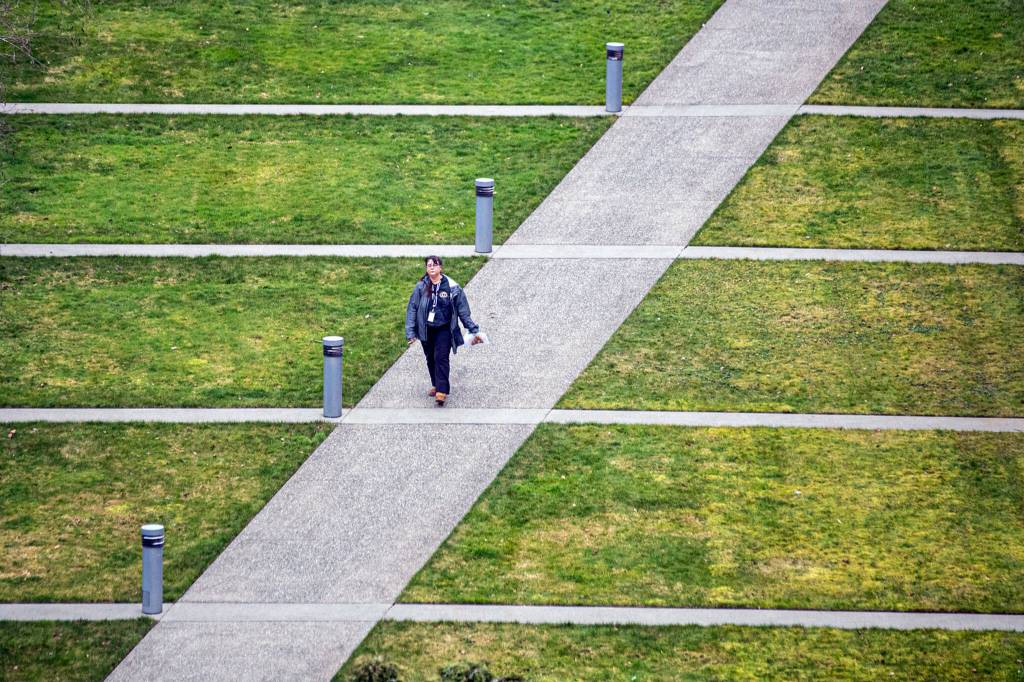 A woman walking along the path is seen from Snohomish Superior Courthouse in Everett on Feb. 15. (Kevin Clark / The Herald )