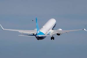 FILE - The final version of the 737 MAX, the MAX 10, takes off from Renton Airport in Renton, Wash., on its first flight Friday, June 18, 2021.  A judge has approved a settlement of a lawsuit, Thursday, Feb. 24, 2022, in which Boeing investors accused company directors of failing to properly oversee safety issues around the 737 Max. Under the settlement, insurers for several current and former Boeing directors will pay $237.5 million.    (Ellen M. Banner/The Seattle Times via AP, Pool)