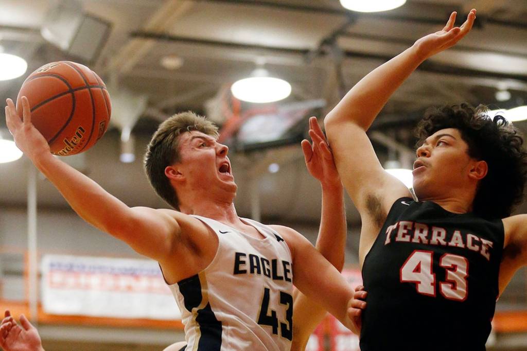 Don Brown defends a shot during the Hawks shutdown performance against Arlington in last weeks district semifinal. (Ryan Berry / The Herald)