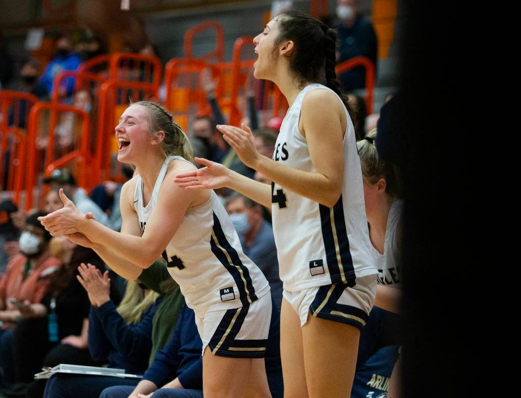 Arlingtons Keira Marsh and Jenna Villa cheer on their teammates. (Olivia Vanni / The Herald)