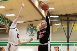 Archbishop Murphy forward Claire Esping throws up a shot against W.F. West in the regional round of the state tournament at Tumwater Feb. 25. (Alec Dietz / The Chronicle)