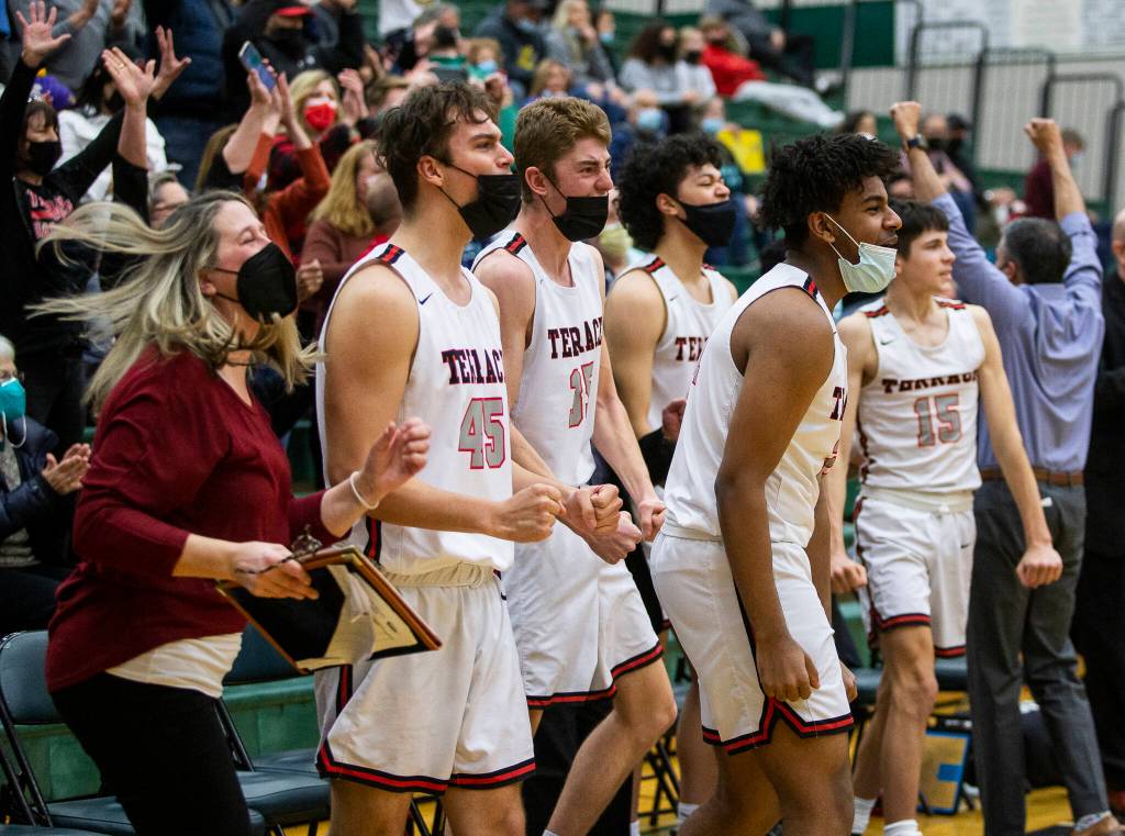 The Mountlake Terrace bench reacts to beating Kelso in overtime on Saturday, Feb. 26, 2022 in Mill Creek, Washington. (Olivia Vanni / The Herald)