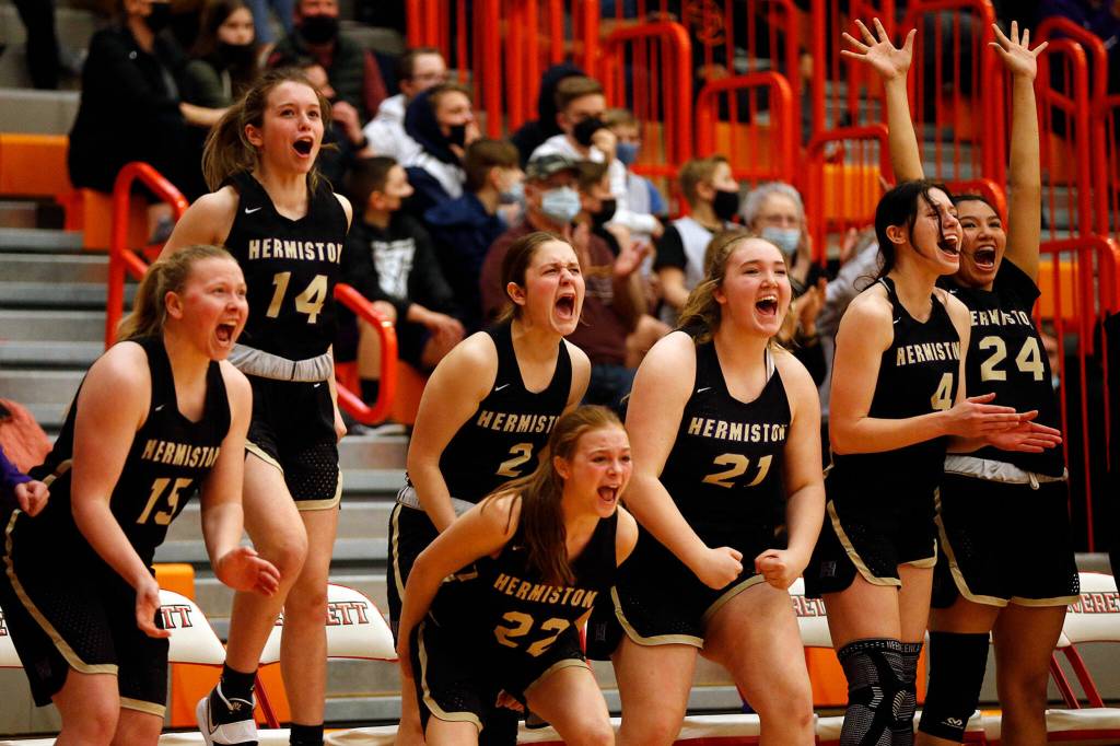 The Hermiston bench goes crazy after a late-game score against Everett Saturday, Feb. 26, 2022, during a Class 3A regional matchup at Everett Community College in Everett, Washington. (Ryan Berry / The Herald)