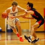 Lakewoods Blake Conyers tries to get away from a defender against Sammamish Saturday, Feb. 26, 2022, during a Class 2A regional matchup at Everett Community College in Everett, Washington. (Ryan Berry / The Herald)