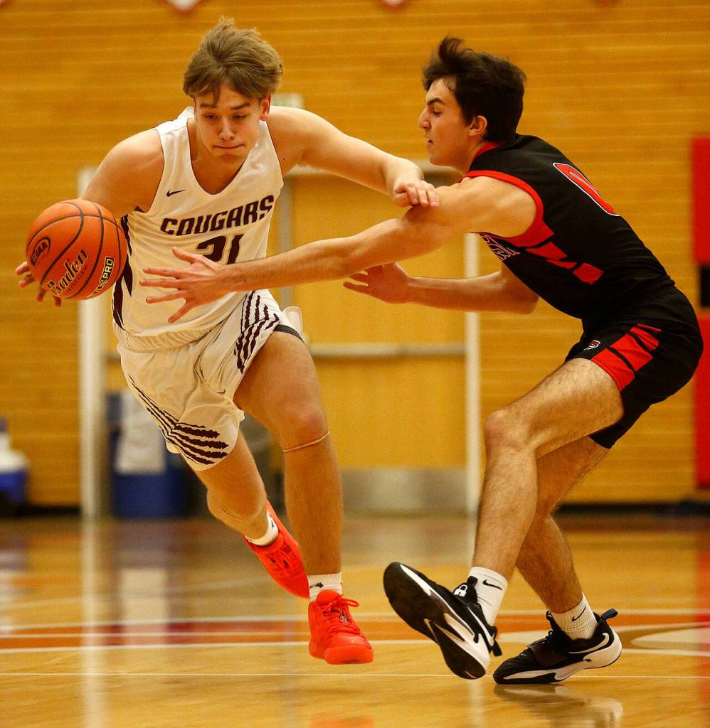 Lakewoods Blake Conyers tries to get away from a defender against Sammamish Saturday, Feb. 26, 2022, during a Class 2A regional matchup at Everett Community College in Everett, Washington. (Ryan Berry / The Herald)