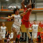 Graham-Kapowsins Joshua Wood scores over a defender against Glacier Peak Saturday, Feb. 26, 2022, during a Class 4A regional matchup at Everett Community College in Everett, Washington. (Ryan Berry / The Herald)