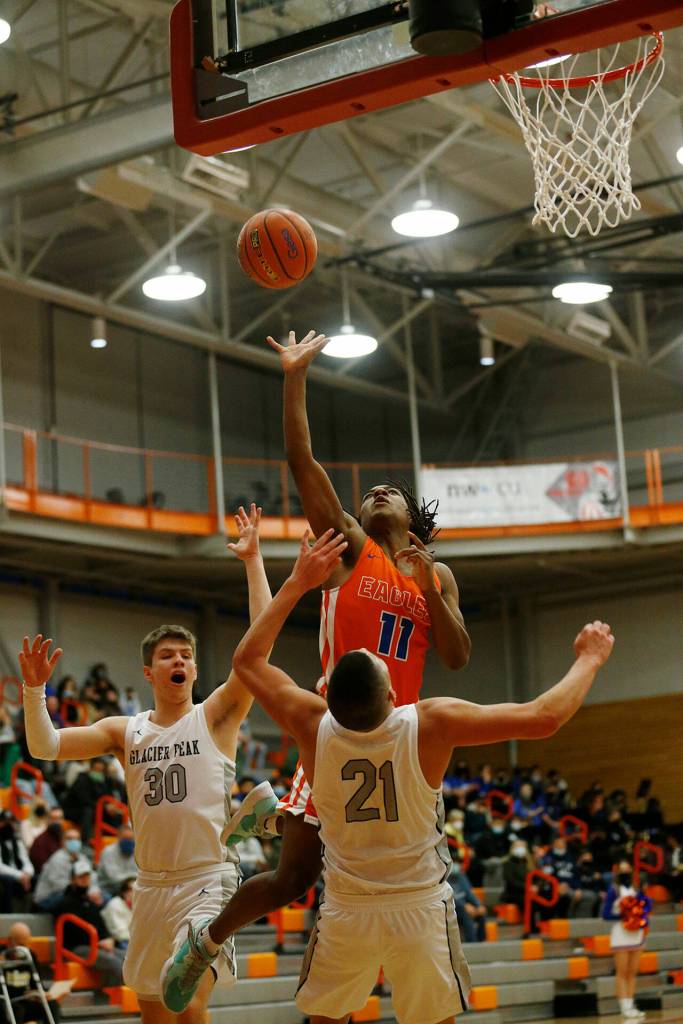 Graham-Kapowsins Nicholas Hunter takes a close range shot against Glacier Peak Saturday, Feb. 26, 2022, during a Class 4A regional matchup at Everett Community College in Everett, Washington. (Ryan Berry / The Herald)