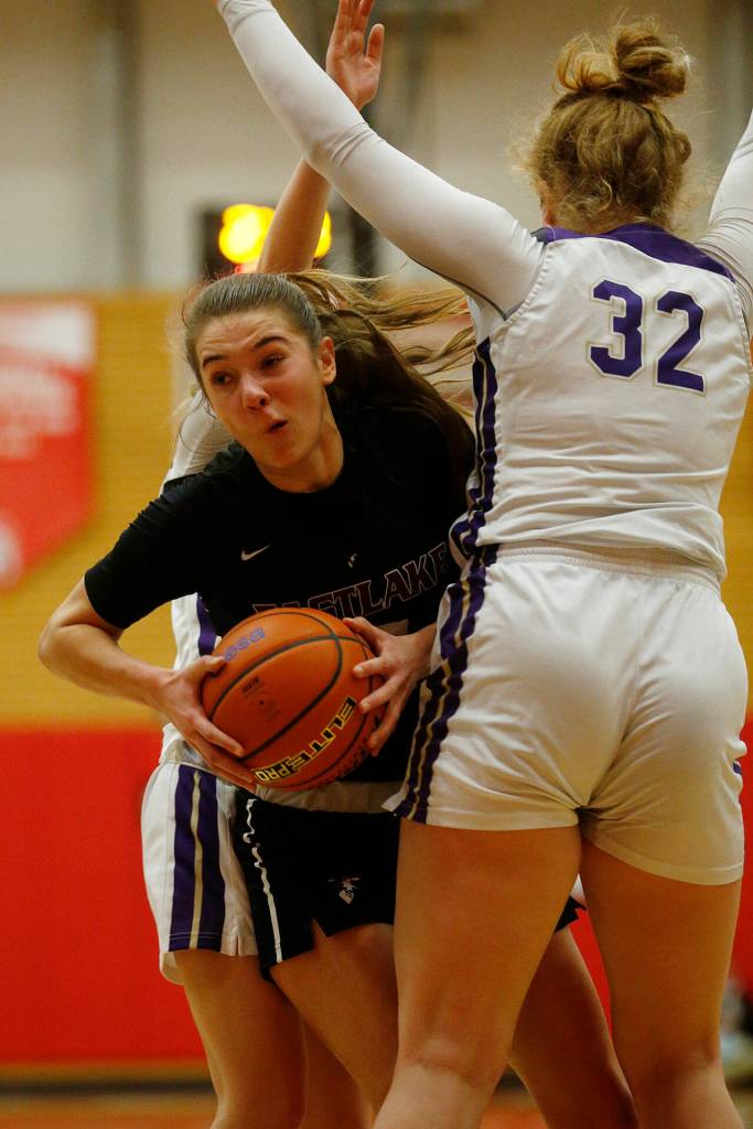 Eastlakes Sophia Aluas tries to spin through the defense against Lake Stevens Saturday, Feb. 26, 2022, during a Class 4A regional matchup at Everett Community College in Everett, Washington. (Ryan Berry / The Herald)