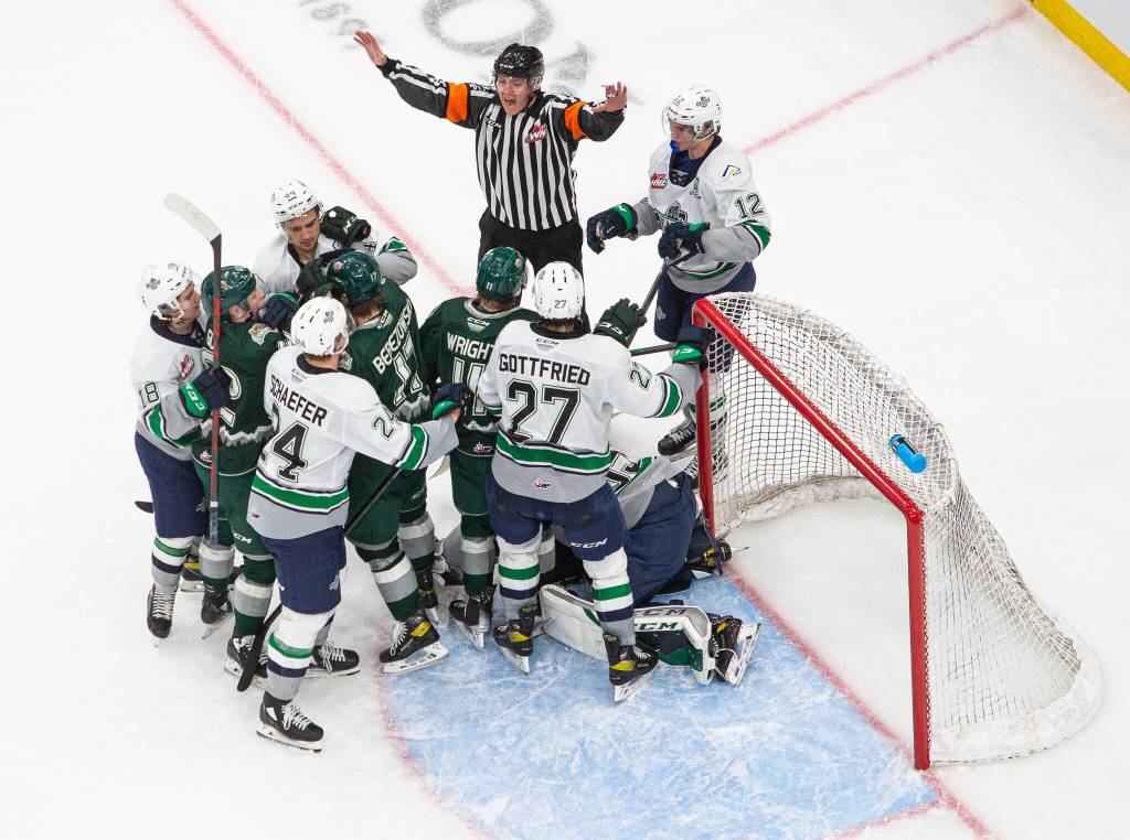 A referee yells while fights breakout in front of the Seattle Thunderbirds goal during the game at Climate Pledge Arena on Saturday, Feb. 26, 2022 in Seattle, Washington. (Olivia Vanni / The Herald)
