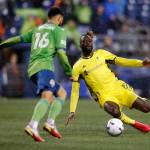 Nashville SC’s CJ Sapong tries to make a sliding tackle during the opening game of the 2022 season against Seattle on Sunday, Feb. 27, 2022, at Lumen Field in Seattle, Washington. (Ryan Berry / The Herald)