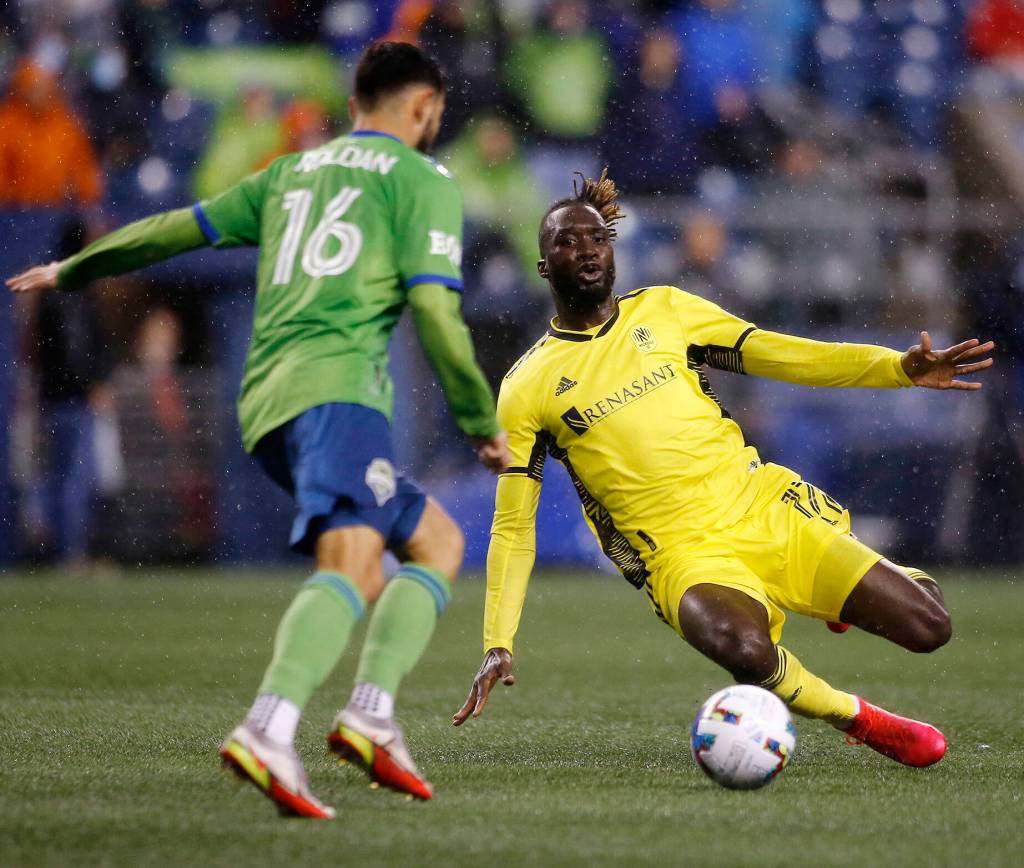 Nashville SCs CJ Sapong tries to make a sliding tackle during the opening game of the 2022 season against Seattle on Sunday, Feb. 27, 2022, at Lumen Field in Seattle, Washington. (Ryan Berry / The Herald)
