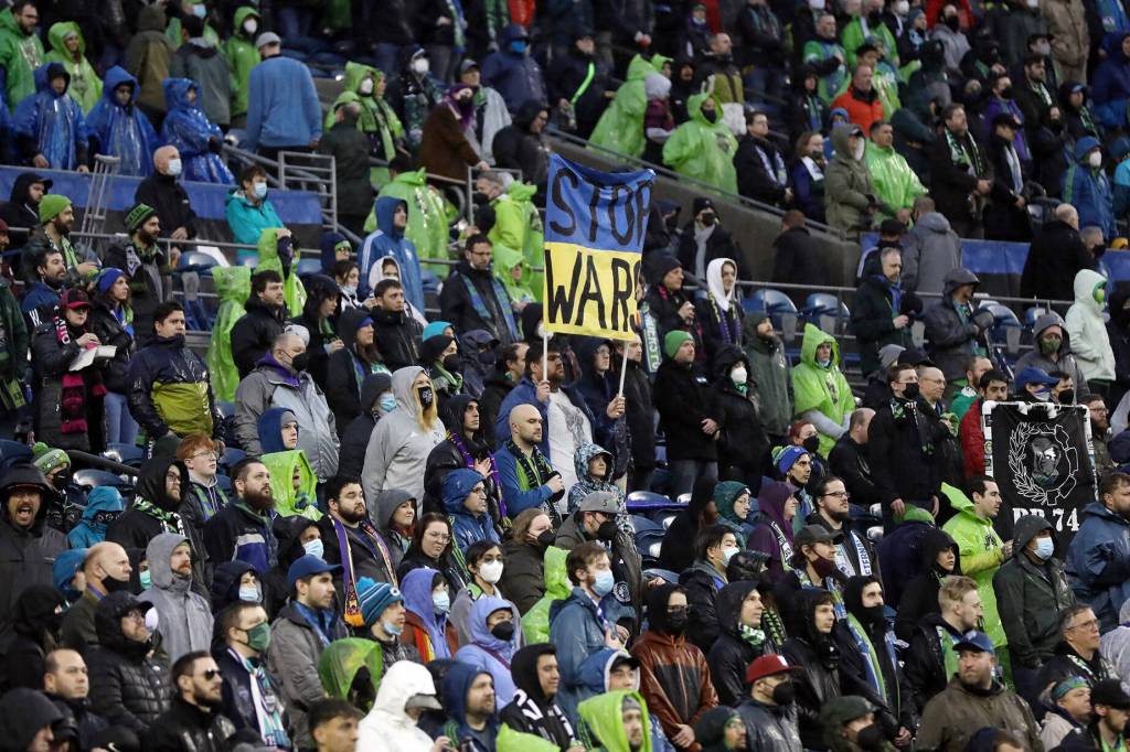 A fan protests the conflict in Ukraine before the Seattle Sounders opening game of the 2022 season against Nashville SC on Sunday, Feb. 27, 2022, at Lumen Field in Seattle, Washington. (Ryan Berry / The Herald)